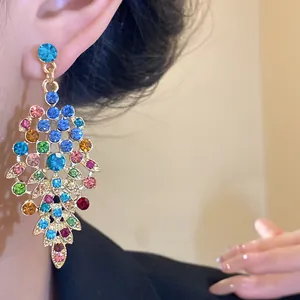 Close-up of colorful zircon leaf drop earring with vintage palace style gold finish