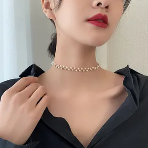 Detailed close-up showing an elegant double-row pearl choker necklace on a model.