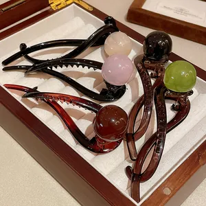 Close-up view of elegant Korean style resin duckbill hair clips with colorful round beads.