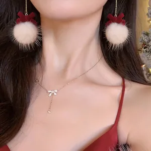 Elegant Christmas plush ball earrings with red velvet bow and matching bow necklace