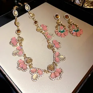 Elegant French vintage jewelry set featuring pink cat's eye stones and rhinestones.