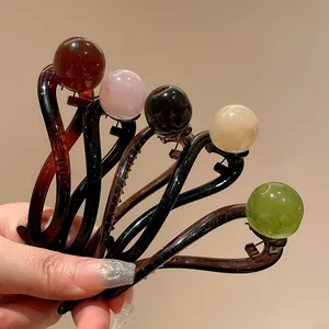 Macro view showing multiple colors and textures of elegant resin bead hair clips.