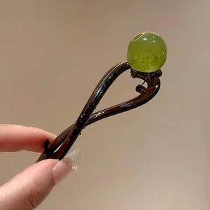 Close-up of a Korean resin hair clip with a translucent green bead detail