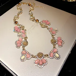 Detailed view of French vintage necklace with pink cat's eye stones and rhinestones