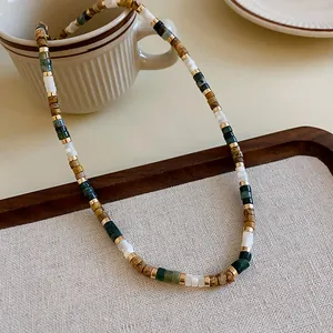 Close-up detail of ethnic style titanium steel necklace with mixed shell beads