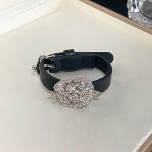 Elegant black leather strap bracelet with a large sparkling rhinestone rose flower.