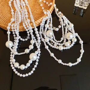 Close-up of elegant multi-layered irregular pearl necklace with vintage gold-tone accents