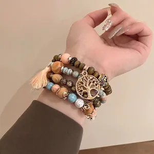 Bohemian multi-layer beaded bracelet set with tree of life charm and tassel detail