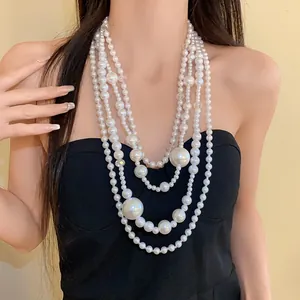 Detailed view of multi-layered irregular pearl necklace on model for vintage luxury style