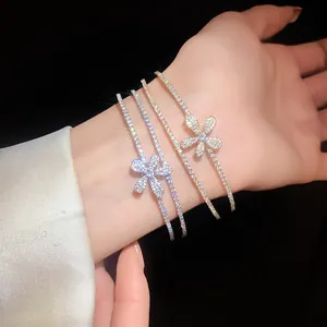 Detail of zircon flower double-layer open bracelets in shiny gold and silver finishes