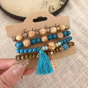 Close-up detail of bohemian beaded bracelet set featuring blue tassel and tree of life