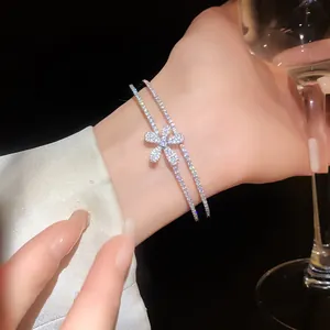 Macro detail shot of a double-layer open bracelet with a sparkling zircon flower motif