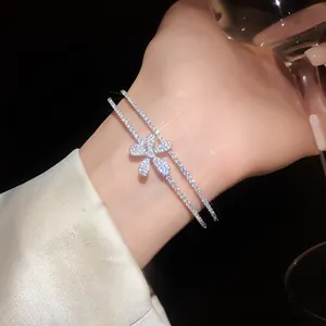 Detailed shot of a sparkling zircon flower double-layered open bangle for women.
