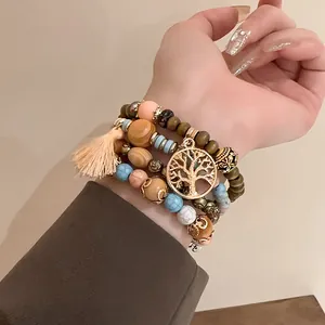Detailed shot of Bohemian multi-layer beaded bracelet featuring a Tree of Life charm.