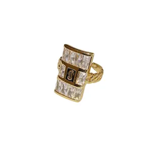Gold-tone zircon square ring featuring letter S logo and curb chain adjustable band