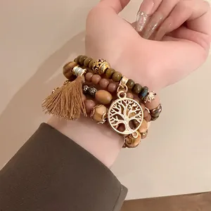 Close-up of a Bohemian beaded bracelet set featuring a life tree charm and tassel