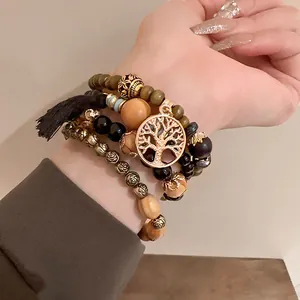 Close-up detail of Bohemian multi-layer beaded bracelet set with Tree of Life charm and tassel