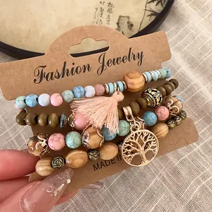 Detailed view of Bohemian beaded bracelet set with tassel and tree of life charm