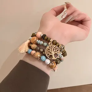 Bohemian multi-layer beaded bracelet set with gold Tree of Life charm and peach tassel.