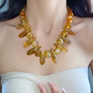 Chunky marbled acrylic irregular oval necklace shown on an elegant female model
