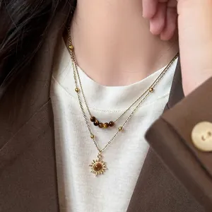 Vintage gold sun pendant necklace with tiger eye beads in a stylish double layer design