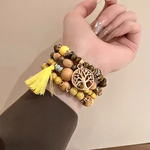 Detailed view of Bohemian beaded bracelet set with yellow tassel and Tree of Life charm