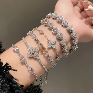 Detailed view of silver-toned bracelets with sparkling heart and flower zirconias