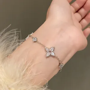 Detailed shot of a delicate silver flower bracelet with sparkling cubic zirconia on wrist
