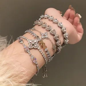 Detailed view of layered silver zircon bracelets with heart and flower motifs