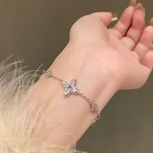 Close-up showing the elegant silver zircon flower bracelet worn on a female wrist detail