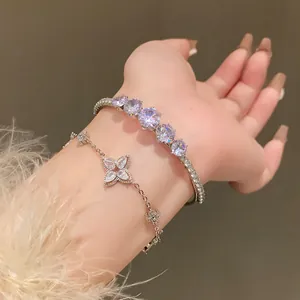 Detail view of Korean style sparkling zircon flower and round stone bracelets on wrist