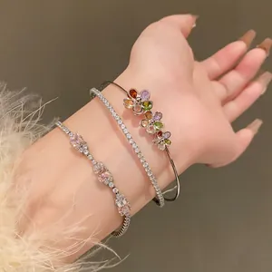 Detailed view of sparkly zircon flower and pink gemstone bracelet set on wrist