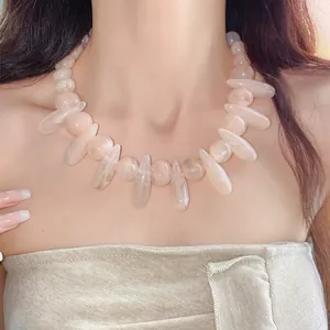 Detail shot of chunky pink marbled acrylic necklace with irregular oval beads