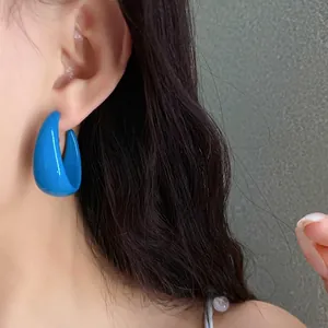 Fashionable bright blue C-shaped acrylic stud earrings for women with a high gloss finish