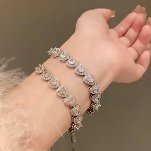 Close-up of sparkling heart-shaped zircon bracelets with pavé halo detailing on wrist