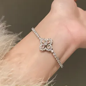 Close-up detail of a sparkling zircon flower bracelet on a woman's wrist with elegant style