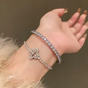 Close-up detail of double layered Korean style zircon bracelets with flower charm