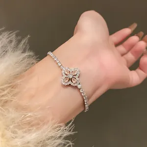 Detailed view of champagne zircon flower charm on a sparkling tennis bracelet