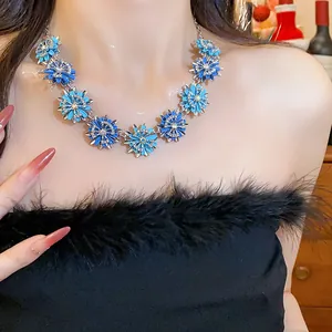 Close-up of elegant blue floral necklace with sparkling diamond-encrusted details