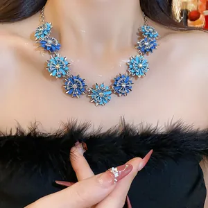 Elegant blue flower necklace with shimmering rhinestones worn by a model for a vintage look