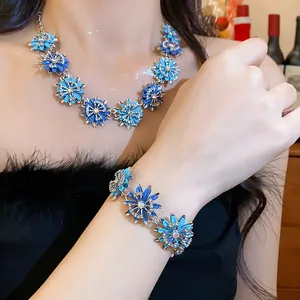 Elegant close-up of a blue floral necklace and bracelet jewelry set with crystal accents