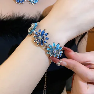 Close-up of vintage blue flower bracelet with rhinestones worn by model