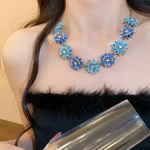 Detail view of luxury blue flower necklace with sparkling crystals worn by model