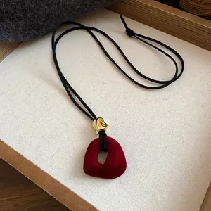Elegant retro red flocked pendant necklace with gold accent bead on black velvet cord