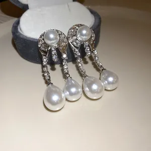 Eleganti orecchini in argento con diamanti e perle a forma di goccia stile vintage.