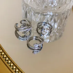 Macro view of silver starburst open rings with shimmering zircon accents