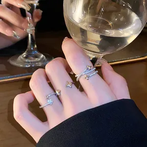 Elegant close-up of a sparkling star-shaped open ring featuring zircons on a finger
