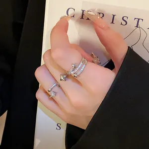 Close-up detail of a silver-toned star open ring with sparkling zircon stone inlays.
