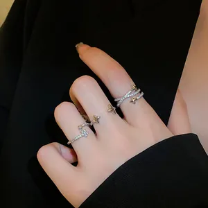 Close-up detail showing sparkling cubic zirconia star rings with an elegant silver finish
