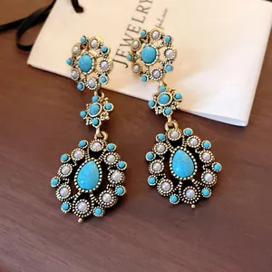 Vintage-style earrings with turquoise-colored stone and pearl floral water drop design